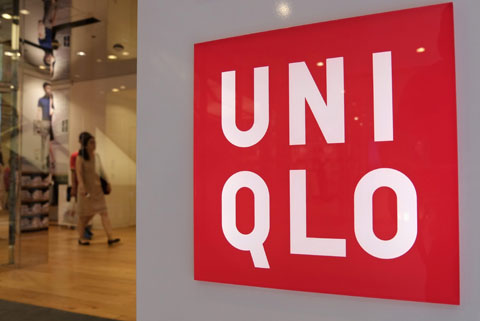 Shoppers walk inside Fast Retailing's Uniqlo casual clothing store in Tokyo