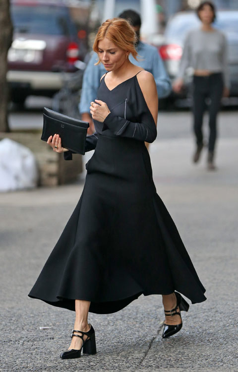 An elegant Sienna Miller steps out wearing an off the shoulder black dress